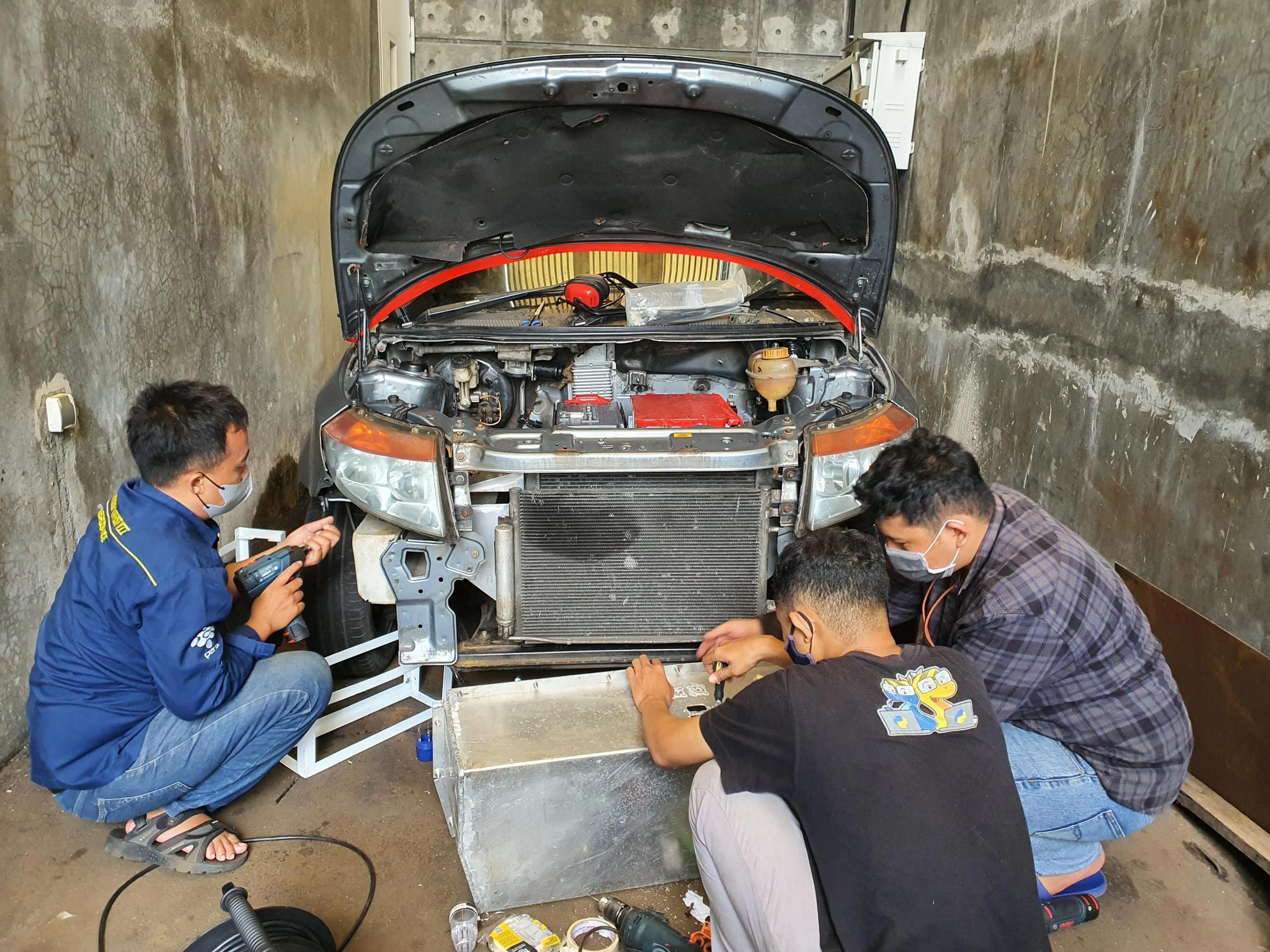 Teams fixing car